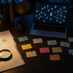 Research desk with source documents, connected evidence notes, and branching search paths on a laptop